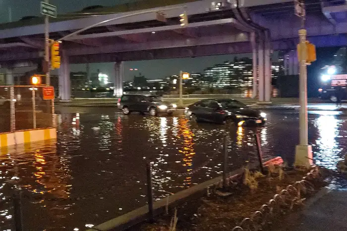 Cars traverse flooded streets after a water main broke under South Street Monday.